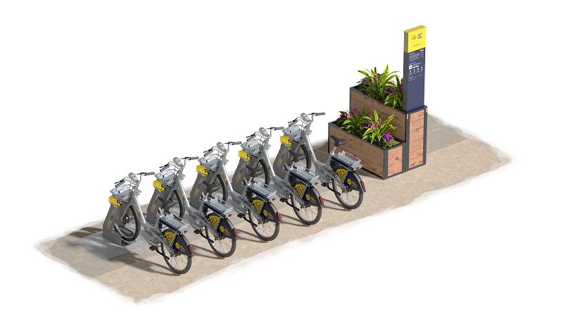 Beryl bikes parked up at a docking station with totem sign and planting