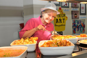 woman serving up school dinners