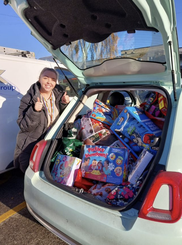 Family Plus service image showing person with a car full of products to support families in need