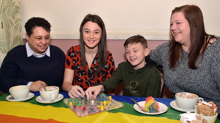 LGBT+ foster family enjoying cake