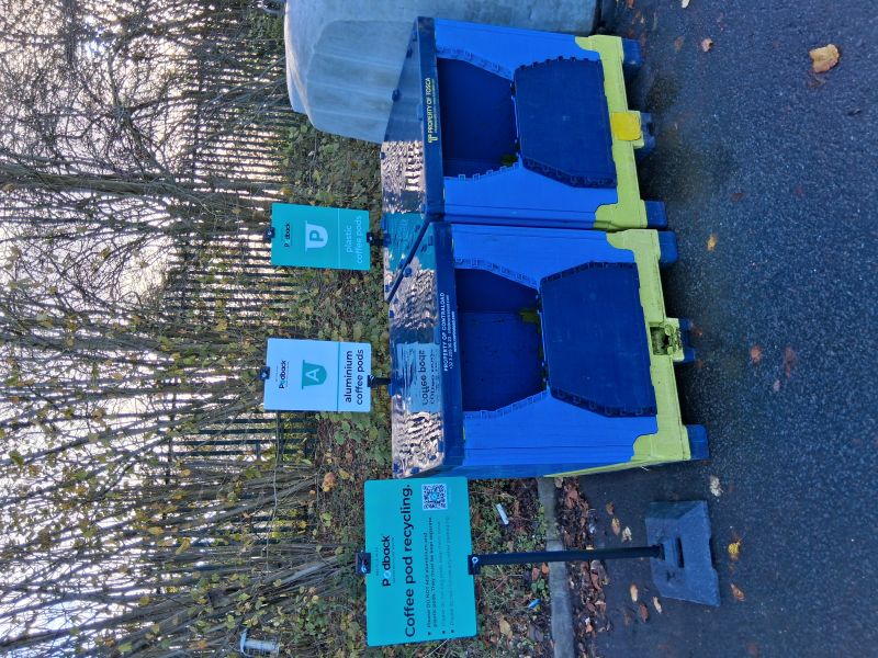 Blue containers with an opening at the front to take used aluminium and plastic coffee pods