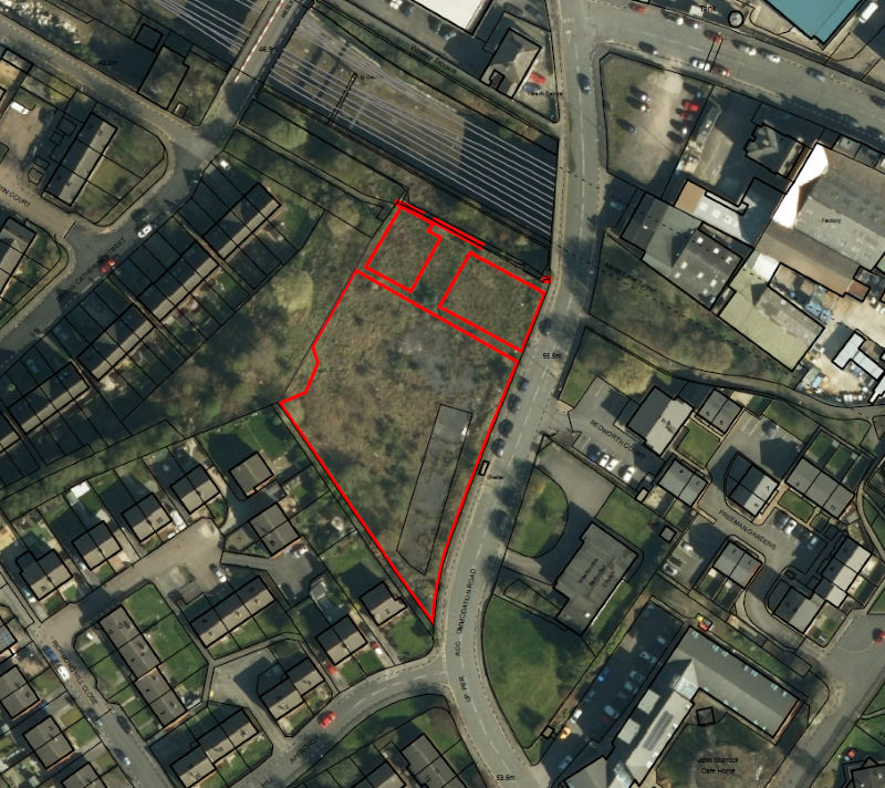  Aerial view of houses and land with red outline