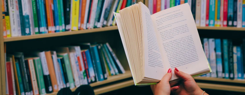 Read for mental health campaign banner showing a book being read in a library