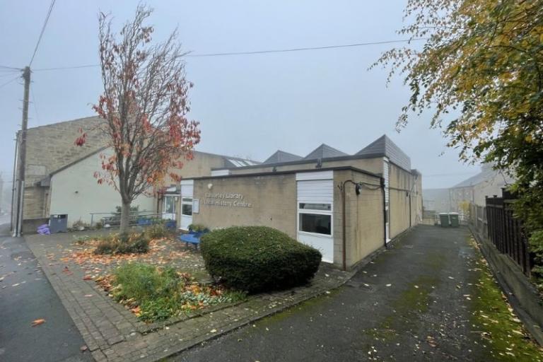 Photograph showing the exterior of the Calverley Library building with landscaping and hardstanding to front and side