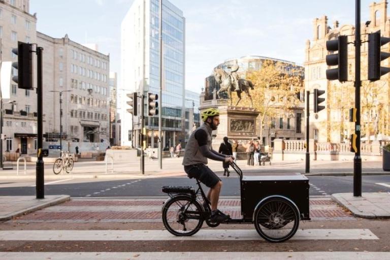 Photo of a rider on the Christiania bike in City Square Leeds