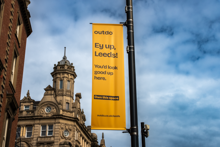 Image shows Outdo advertising banner in Leeds city centre